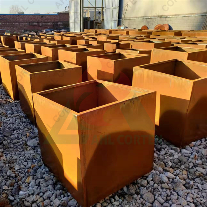 Corten steel flower pot in the garden