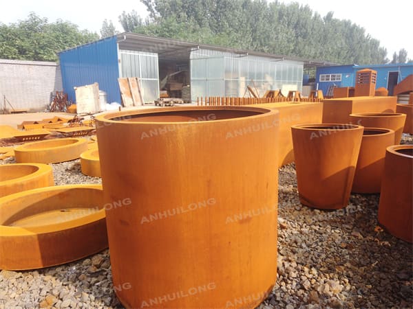 modern rusty-like cylinder palnters for landscaping
